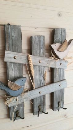 a wooden wall hanging with birds on it