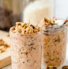 two jars filled with food sitting on top of a table