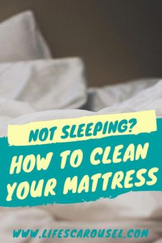 a bed with white sheets and a blue sign that says not sleeping? how to clean your mattress