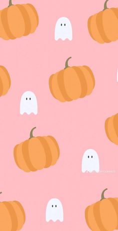 a pink background with pumpkins and ghost faces