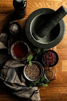 an assortment of spices and seasonings on a wooden table