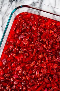 a glass casserole dish filled with cranberry sauce