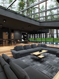 a living room filled with lots of furniture next to a large glass ceiling over a pool