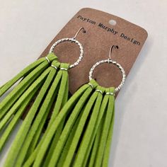 "\"Pippin\" is a super fun pair of apple green leather fringe style earrings. The leather has been securely wrapped with wire and is set onto matching silver rings and accented with matching ear wires.  The earrings measure 5 inches in length from top of the ear wire to the end of the fringe. The fringe itself measures roughly 3.5 inches long. They measure roughly 0.75 inches wide.  Your new earrings will come perfectly packaged in a navy organza bag, perfect for gift giving or to keep your new earrings safe.  Please message me with any questions or special request. 9.16.23" Trendy Green Dangle Tassel Earrings, Trendy Green Tassel Dangle Earrings, Adjustable Green Bohemian Wrap Earrings, Adjustable Green Jewelry With Tassels, Adjustable Green Tassel Earrings, Fringe Fashion, New Earrings, Earrings Long, Leather Fringe