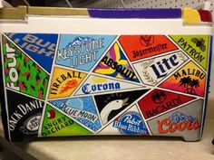 a cooler with many different types of stickers on it's lid and handles