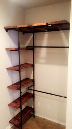 an empty closet with shelving unit in it