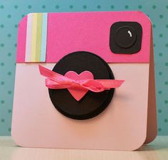 a polaroid camera with a pink bow on it