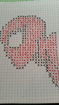 a cross stitch pattern with red and black stars in the shape of a speech bubble