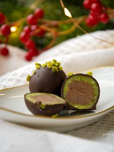 three pieces of chocolate on a plate with christmas decorations in the backgroung