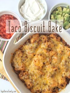 taco biscuit bake in a white casserole dish with toppings