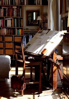 an easel sitting in front of a bookshelf filled with books