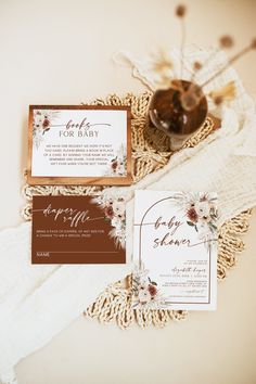 the wedding stationery is laid out on a lace doily, along with some flowers