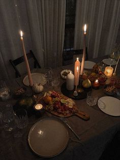 a dinner table with candles and food on it