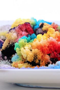 a white bowl filled with lots of colorful powdered food on top of a table