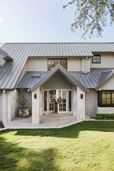 a large white house with a metal roof