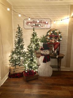 christmas trees and snowmen in front of a sign that reads christmas tree farm on the wall