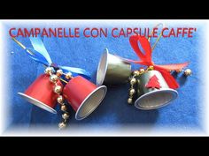 three red and silver cups with bells hanging from the top, on a blue background