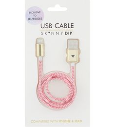 the pink cable is attached to an iphone and ipod charger with gold hardware on it