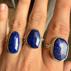 We love this cocktail Lapis ring set in 14k yellow gold. It is accented with gold beads and sits beautifully on Emily's signature Sterling Silver band. Approximate stone size is 20mm x 14mm. Approx ct weight: 10.6 ct Mohs hardness: 5-6 This mixed metal piece is handmade to order in Emily's Hudson Valley studio. Please allow for slight variations in stone color, size and shape. Please allow 14-21 days to ship unless the piece is in stock. If you have questions about sizing, shipping or custom ord Lapis Ring, Local Jewelry, Sterling Silver Bands, Hudson Valley, Mixed Metals, 21 Days, Handmade Sterling Silver, Gold Beads, Silver Band