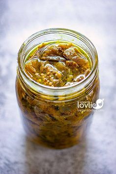 a jar filled with pickles sitting on top of a table