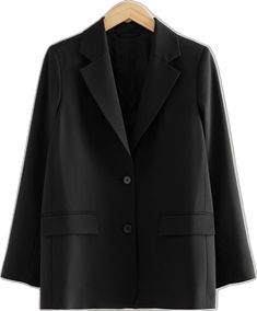 a black blazer jacket hanging on a hanger with a white shirt underneath it