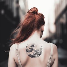 a woman with a tattoo on her back