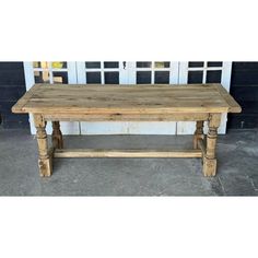 an old wooden table sitting in front of a door