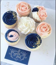 cupcakes with frosting and sprinkles are arranged on a table