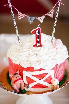 a red and white birthday cake with farm animals on it