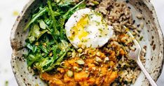 a bowl filled with rice, beans and an egg