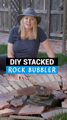 a woman sitting on top of a pile of bricks with the words diy stacked rock bubbler