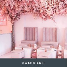 an instagram photo with pink flowers on the wall and white furniture in front of it