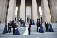 a group of people in formal wear standing on steps