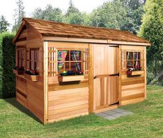 a small wooden shed with windows on the side