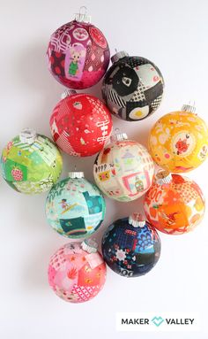 a bunch of different colored ornaments on a white surface