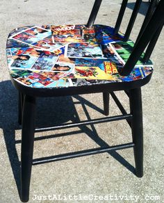 a wooden chair covered in comic books on the ground next to another chair that has been painted