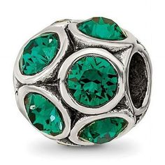 a green crystal bead with silver accents