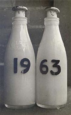 two bottles with numbers on them sitting next to each other