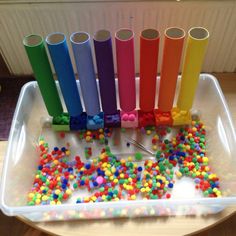 a plastic container filled with lots of different colored candies and sprinkles