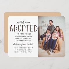 the holiday card features an image of a family sitting on a couch and holding their baby