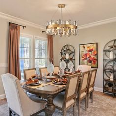 a dining room table with chairs and plates on it