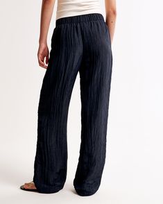 Elevate your wardrobe with the Abercrombie & Fitch Women's Crinkle Textured Pull-On Pants in a stunning Dark Indigo. These ultra high-rise, wide-leg pants are the epitome of comfort and style, crafted from a breezy, crinkle-textured fabric that ensures both durability and breathability.

- Size: Medium
- Color: Dark Indigo
- Material: Body - Polyester, Elastane; Lining - Polyester
- Gender: Female
- Features: Elasticated waistband, functional pockets

Perfect for a casual day out or a relaxed ev Female Features, Stylish Eve, Women's Bottoms, Chic Office, Dark Indigo, Textured Fabric, Pull On Pants, Everyday Look, Modern Woman