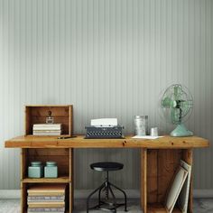 a wooden desk with an old typewriter on it and some books next to it