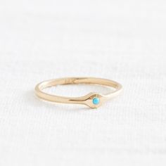 A little blip of color to brighten up your look. This charming little Sleeping Beauty Turquoise is set into a minimal 14k setting. Sleeping Beauty Turquoise is prized for it's even, consistent color and sky-blue hue, and this stone is no exception- the simplicity of the setting allows the bright stone to shine. Comfortable, unique, and feminine: what's not to love? Materials: 14k, 1.6mm Ethically Sourced Sleeping Beauty Turquoise Size: 7.75 ready to ship, can be resized. Allow up to 10 days for Stackable Blue Turquoise Ring In 14k Gold, Turquoise 14k Gold Jewelry With Bezel Setting, Blue Turquoise Ring In 14k Gold, Blue Turquoise 14k Gold Fine Jewelry Ring, Everyday Turquoise 14k Gold Jewelry, Everyday 14k Gold Turquoise Jewelry, Dainty Blue Turquoise Stackable Ring, Dainty 14k Gold Turquoise Gemstone Ring, Turquoise Birthstone Ring In 14k Yellow Gold