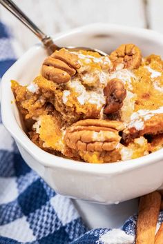 a white bowl filled with food on top of a blue and white checkered table cloth