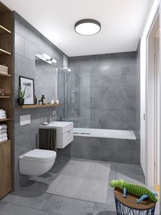 a bathroom with a toilet, sink, and bathtub in grey tiles on the walls