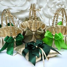 three gold and green purses with bows on them