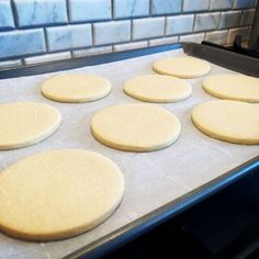 six uncooked cookies are sitting on a cookie sheet