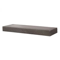 a large rectangular stone shelf with an intricate design on the top and bottom, in grey