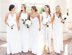 a group of women standing next to each other on top of a brick floored walkway